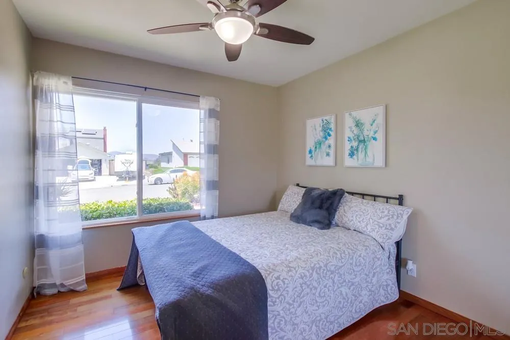 14747 Dash Way Poway, CA 92064 - Photo 25 of 65 a bedroom with a bed and a large window