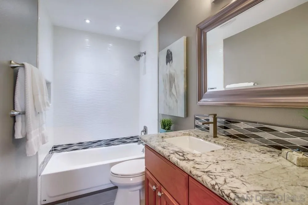 14747 Dash Way Poway, CA 92064 - Photo 26 of 65 a bathroom with a granite countertop sink toilet and shower