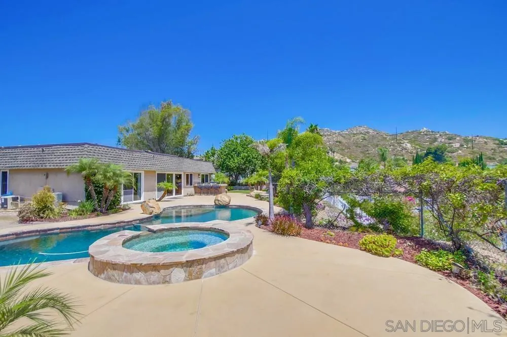 14747 Dash Way Poway, CA 92064 - Photo 35 of 65 a view of a house with a swimming pool and a yard