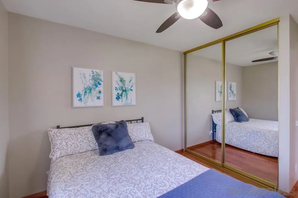 14747 Dash Way Poway, CA 92064 - Photo 52 of 65 a bedroom with a large bed and a chandelier