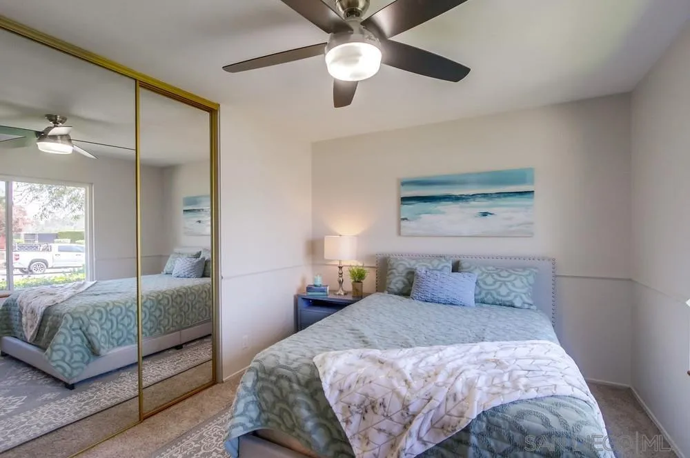 14747 Dash Way Poway, CA 92064 - Photo 53 of 65 a bedroom with a large bed and a chandelier