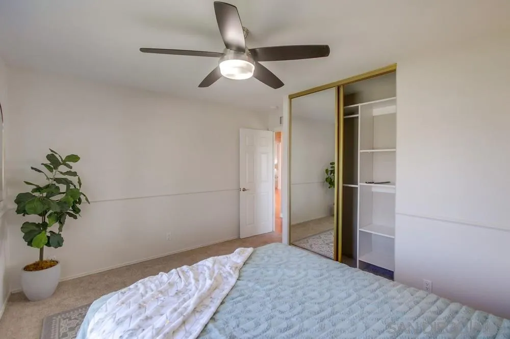 14747 Dash Way Poway, CA 92064 - Photo 54 of 65 a bedroom with a bed and a potted plant