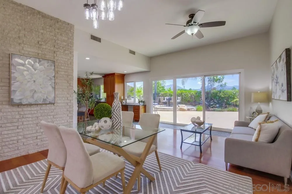 14747 Dash Way Poway, CA 92064 - Photo 9 of 65 a dining room with furniture a chandelier and wooden floor