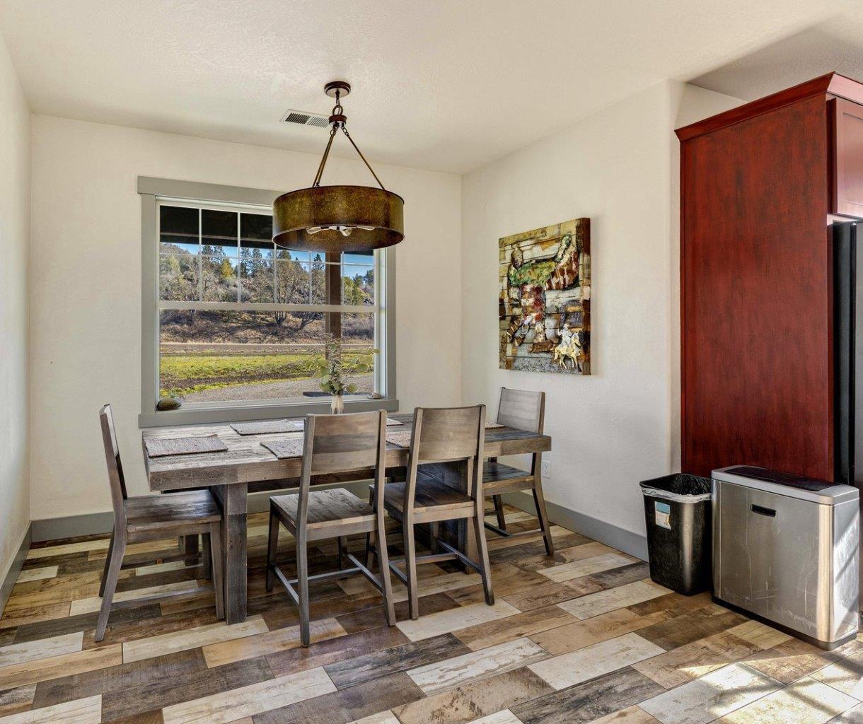 4684 Brownsboro-Meridian Road Eagle Point, OR 97524 - Photo 10 of 33 a dining room with furniture a chandelier and wooden floor