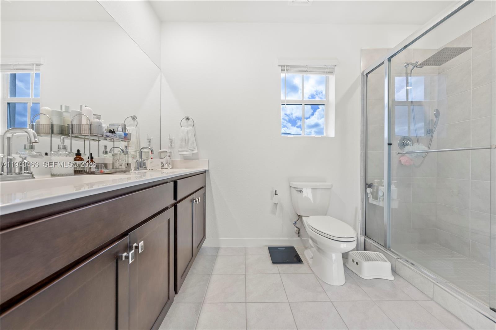 818 Southeast 17 Street, Unit 818 Homestead, FL 33034 - Photo 11 of 36 a bathroom with a sink a toilet and a mirror