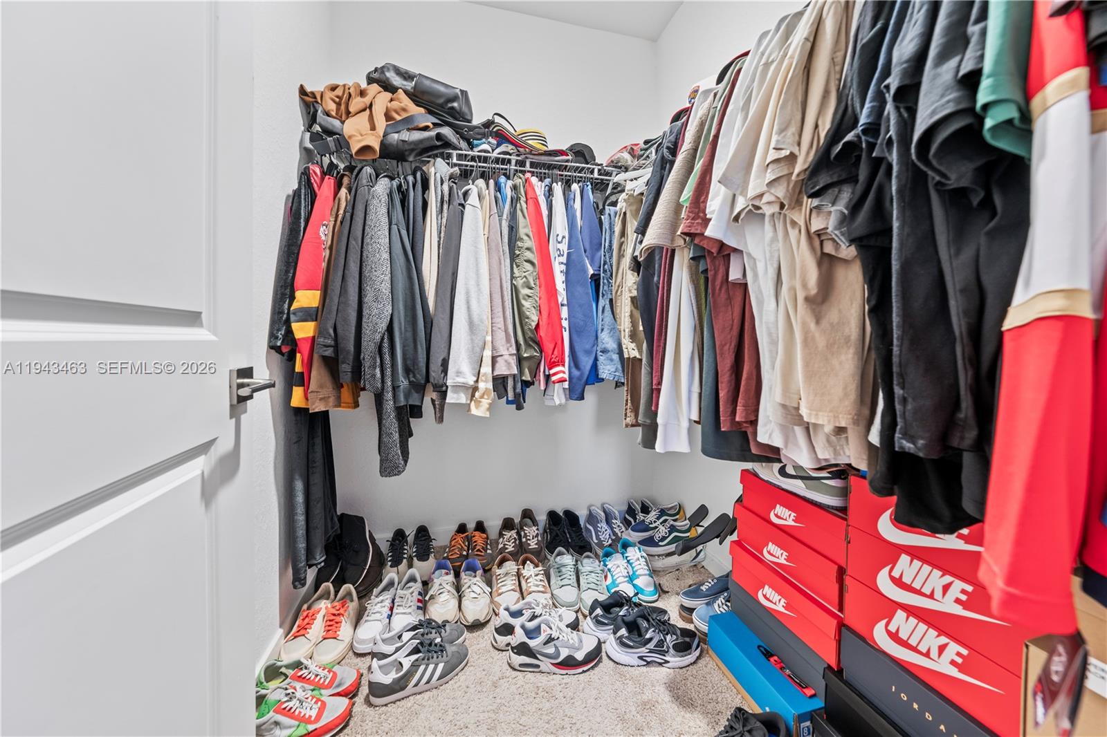 818 Southeast 17 Street, Unit 818 Homestead, FL 33034 - Photo 12 of 36 a view of walk in closet with clothes and shoes