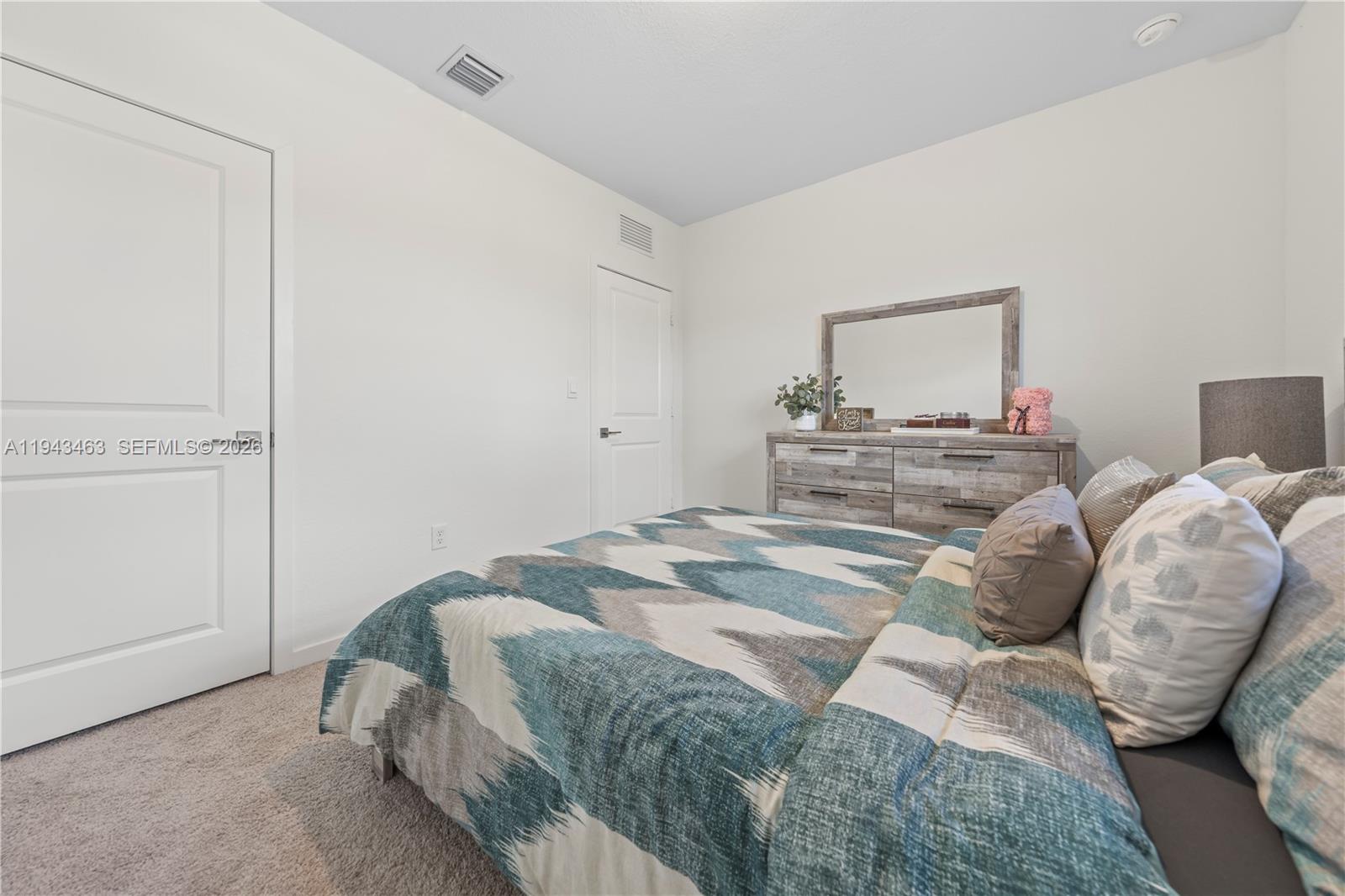 818 Southeast 17 Street, Unit 818 Homestead, FL 33034 - Photo 17 of 36 a bedroom with a bed and window