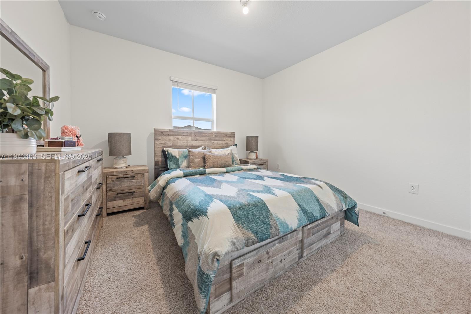 818 Southeast 17 Street, Unit 818 Homestead, FL 33034 - Photo 18 of 36 a bedroom with a bed and a potted plant