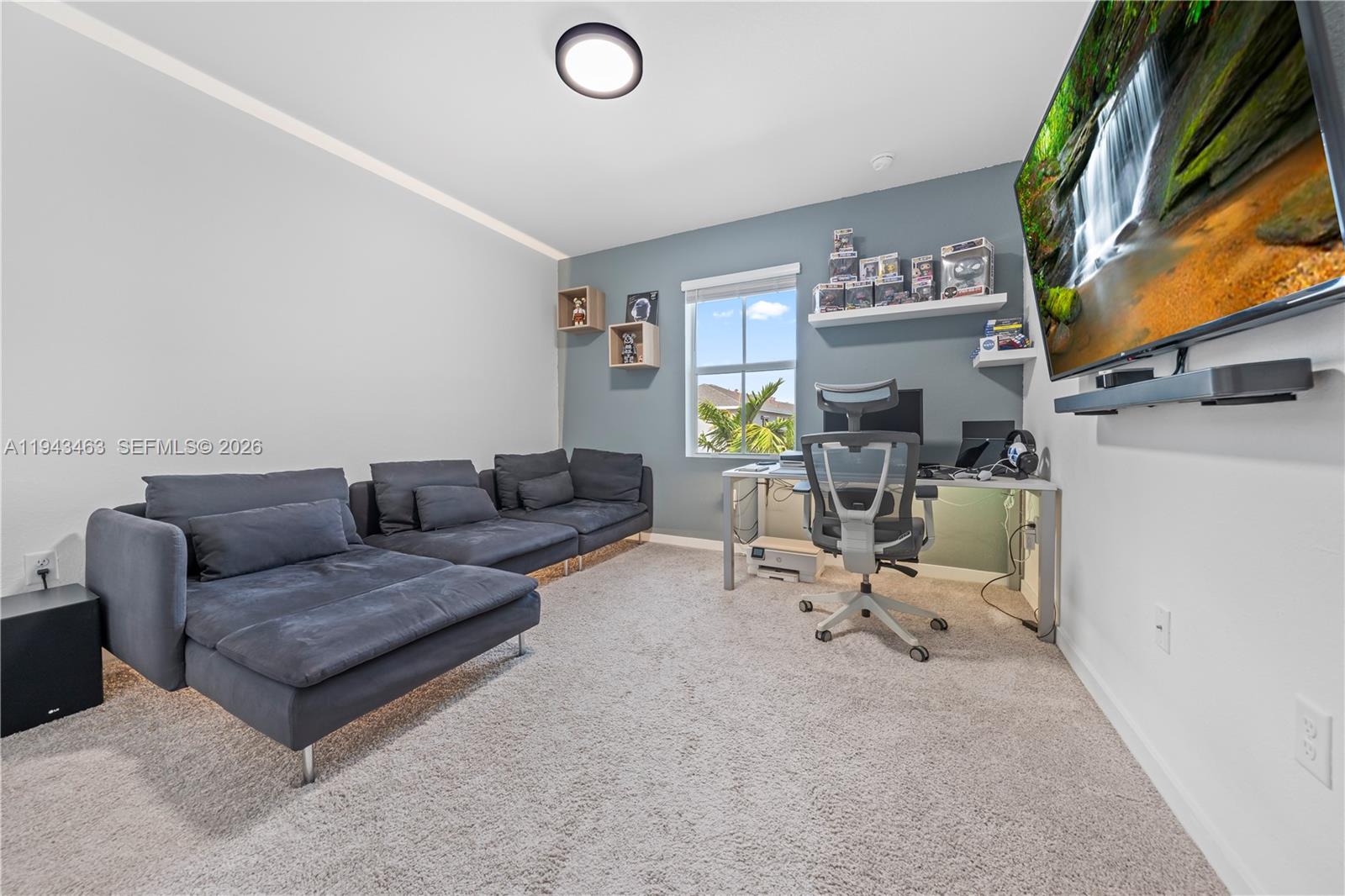 818 Southeast 17 Street, Unit 818 Homestead, FL 33034 - Photo 19 of 36 a living room with furniture and a flat screen tv