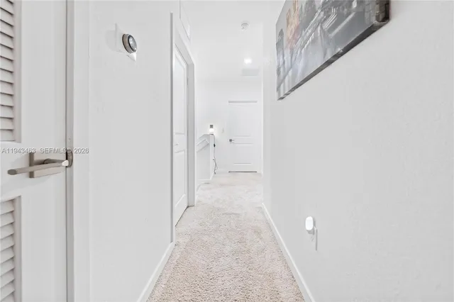 a view of a hallway with white walls