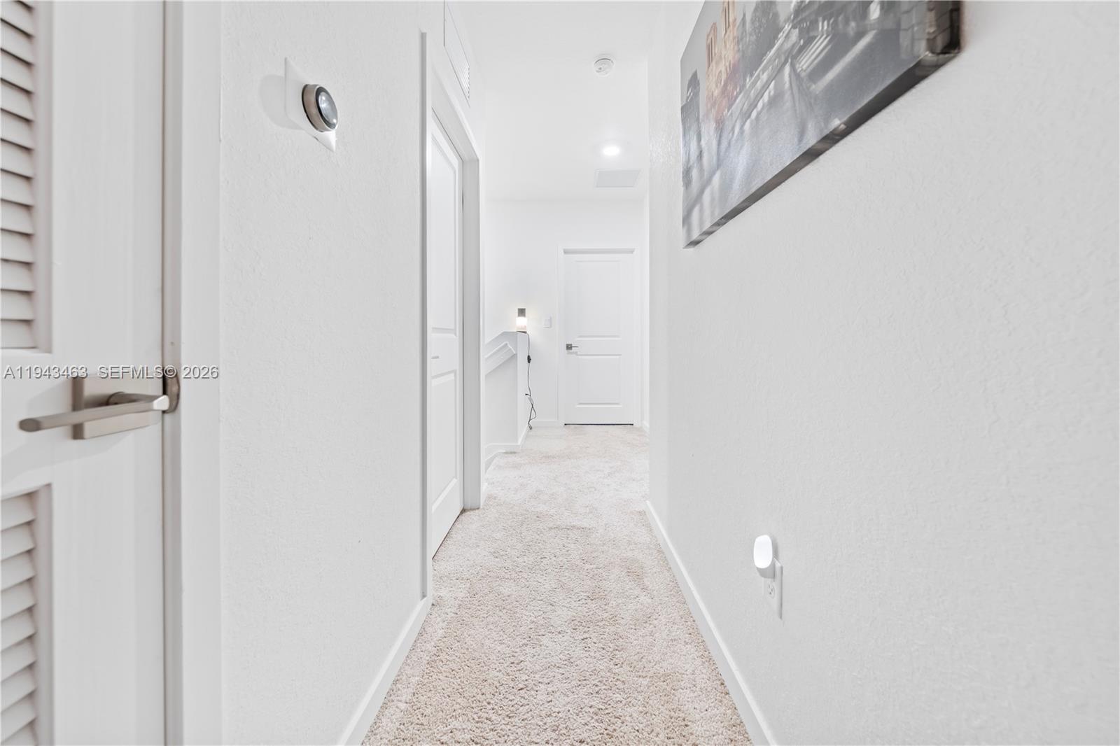 818 Southeast 17 Street, Unit 818 Homestead, FL 33034 - Photo 20 of 36 a view of a hallway with white walls