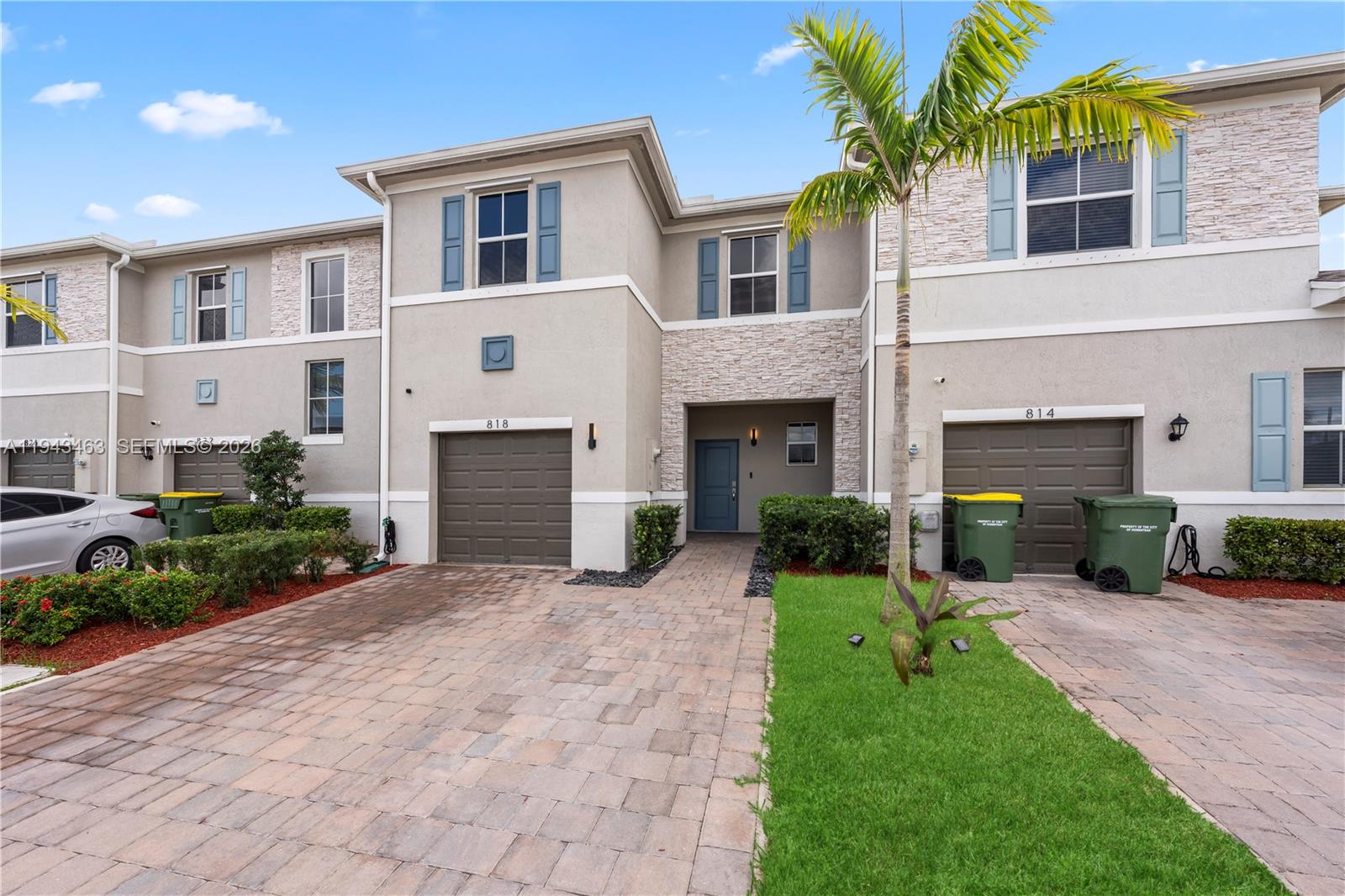 818 Southeast 17 Street, Unit 818 Homestead, FL 33034 - Photo 26 of 36 a front view of a house with a yard and garage