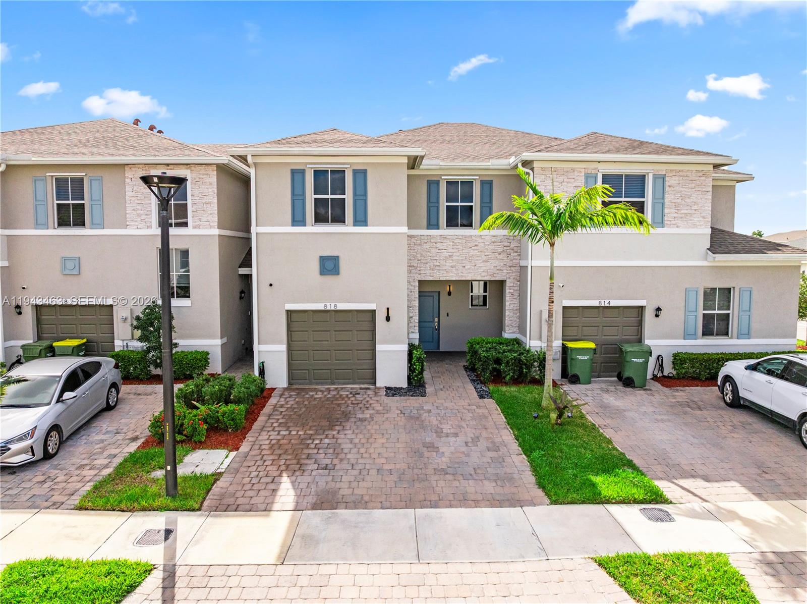 818 Southeast 17 Street, Unit 818 Homestead, FL 33034 - Photo 27 of 36 a front view of a house with garden