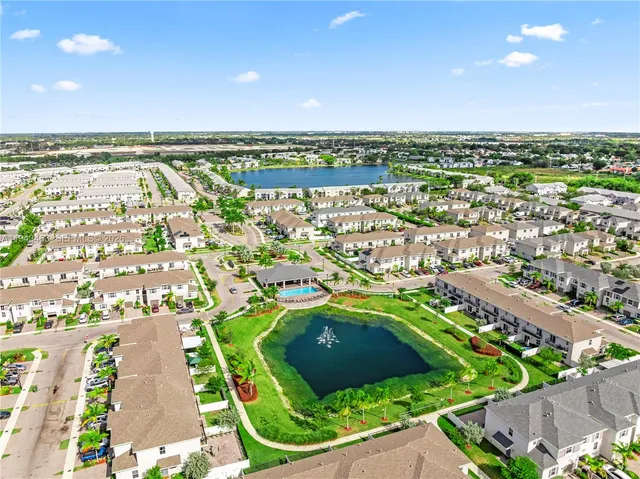 an aerial view of residential houses with outdoor space and river