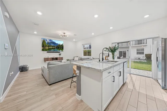a view of living room with granite countertop furniture and a flat screen tv