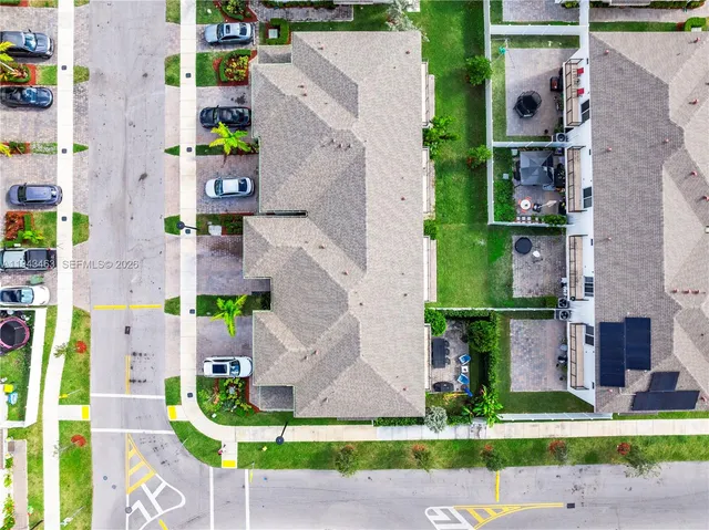 an aerial view of multiple houses with yard