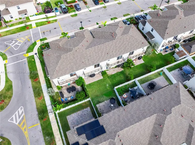 an aerial view of a house a yard and outdoor seating