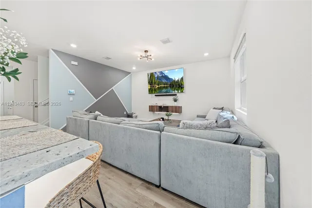 a living room with furniture and a flat screen tv