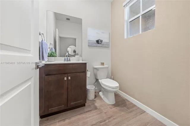 a bathroom with a toilet a sink and mirror