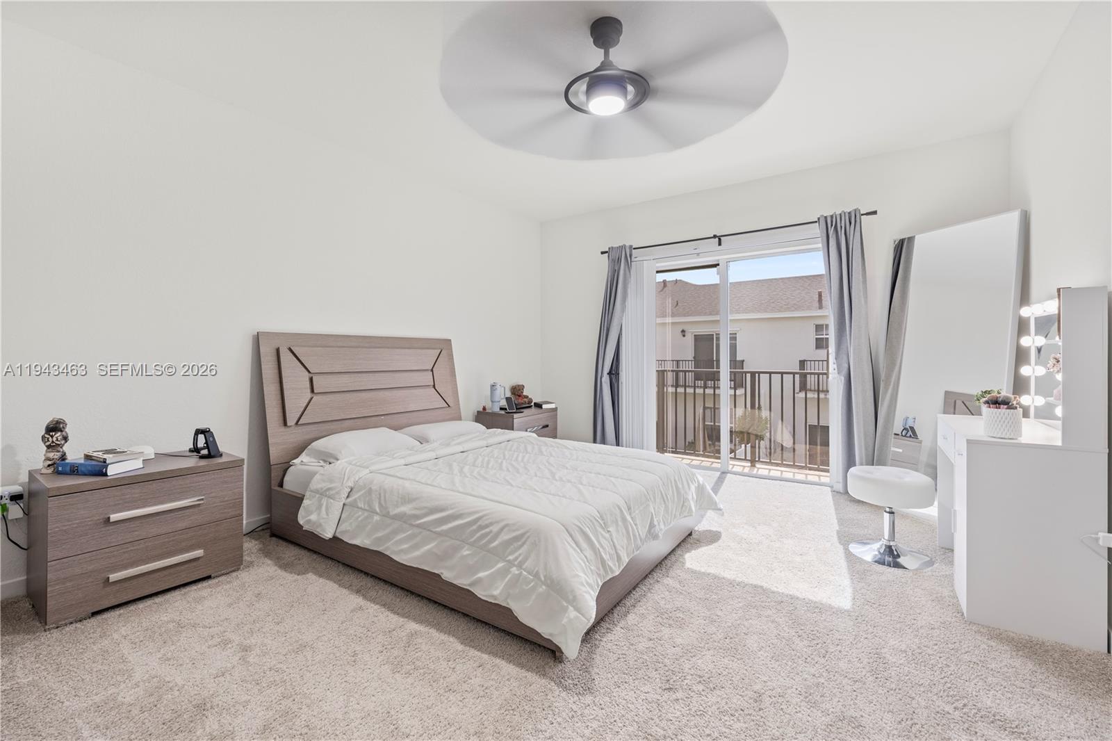 818 Southeast 17 Street, Unit 818 Homestead, FL 33034 - Photo 9 of 36 a bedroom with a bed and a chandelier