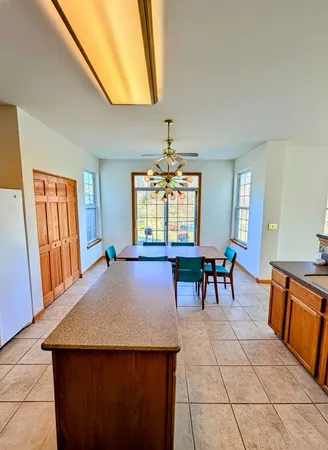 a view of a dining room with furniture and window