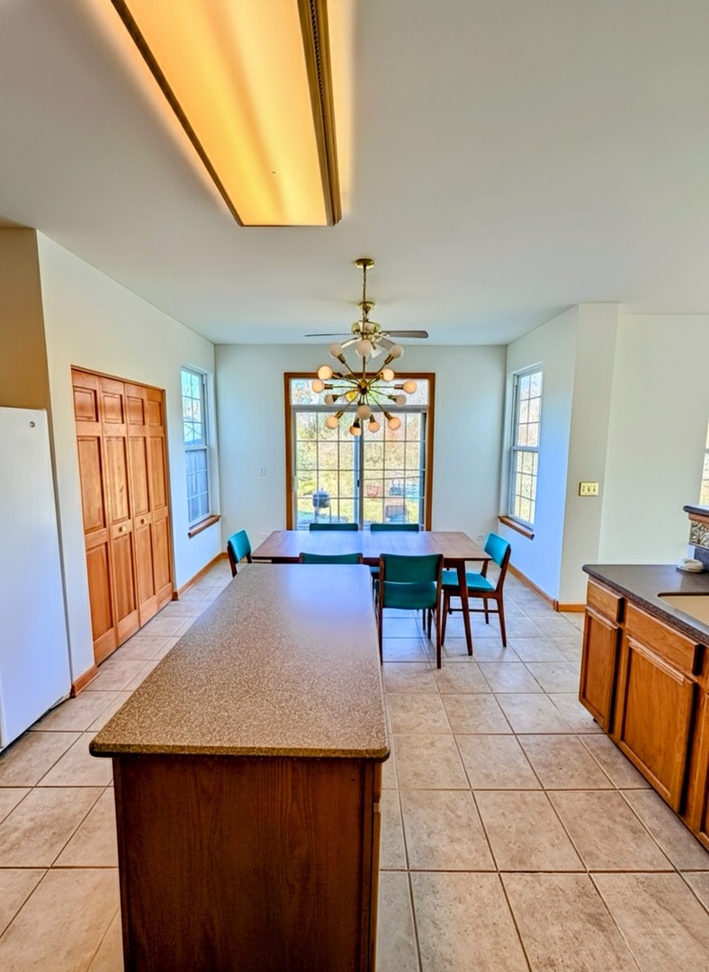 1255 Waterfront Lane Pingree Grove, IL 60140 - Photo 3 of 17 a view of a dining room with furniture and window