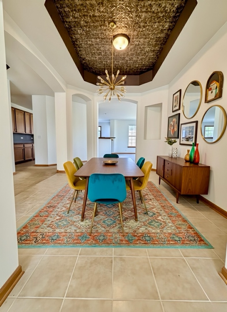 1255 Waterfront Lane Pingree Grove, IL 60140 - Photo 6 of 17 a living room with dining area and a clock