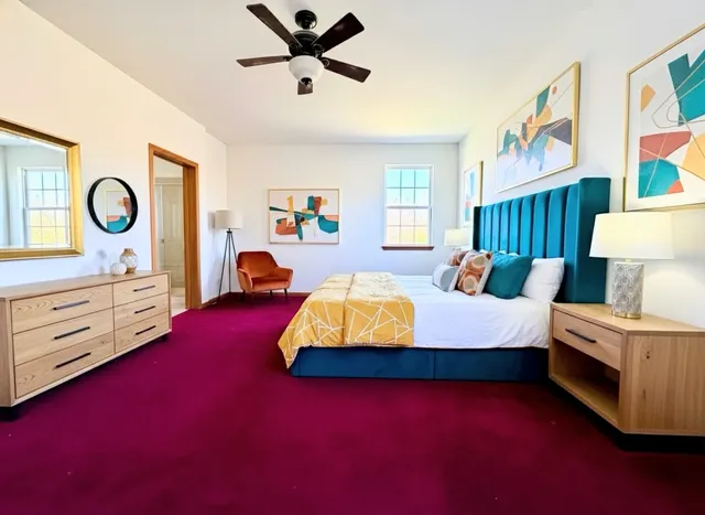 a spacious bedroom with a bed and a window