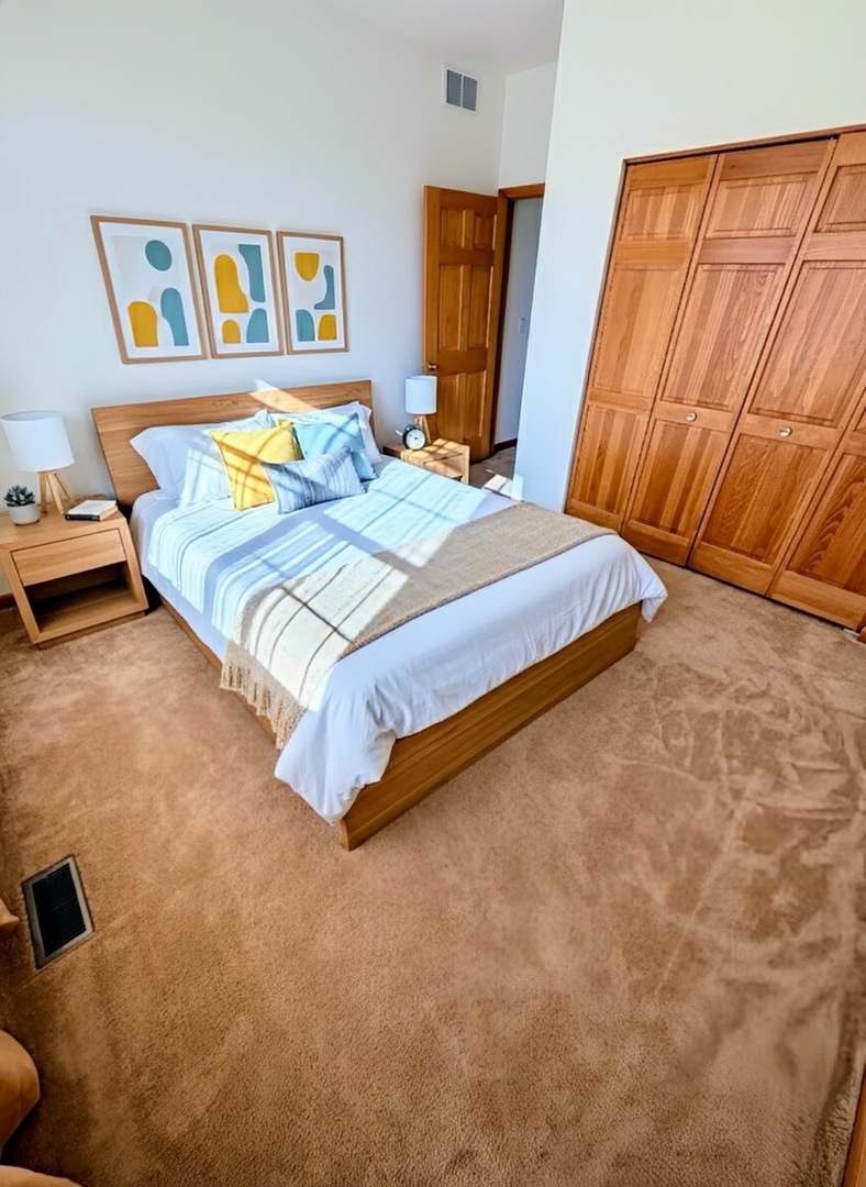 1255 Waterfront Lane Pingree Grove, IL 60140 - Photo 10 of 17 a bedroom with a bed and wooden floor