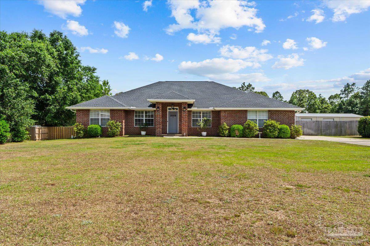a front view of a house with a garden