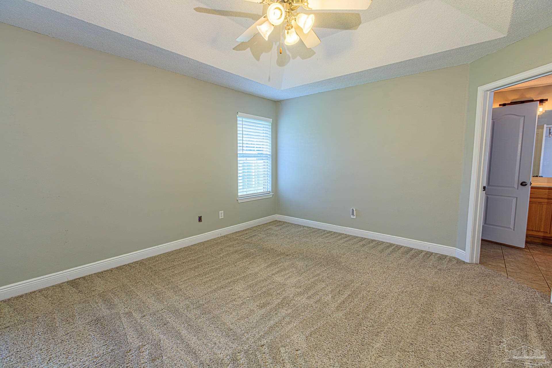 2863 Wallace Lake Road Pace, FL 32571 - Photo 13 of 44 a view of an empty room with a window