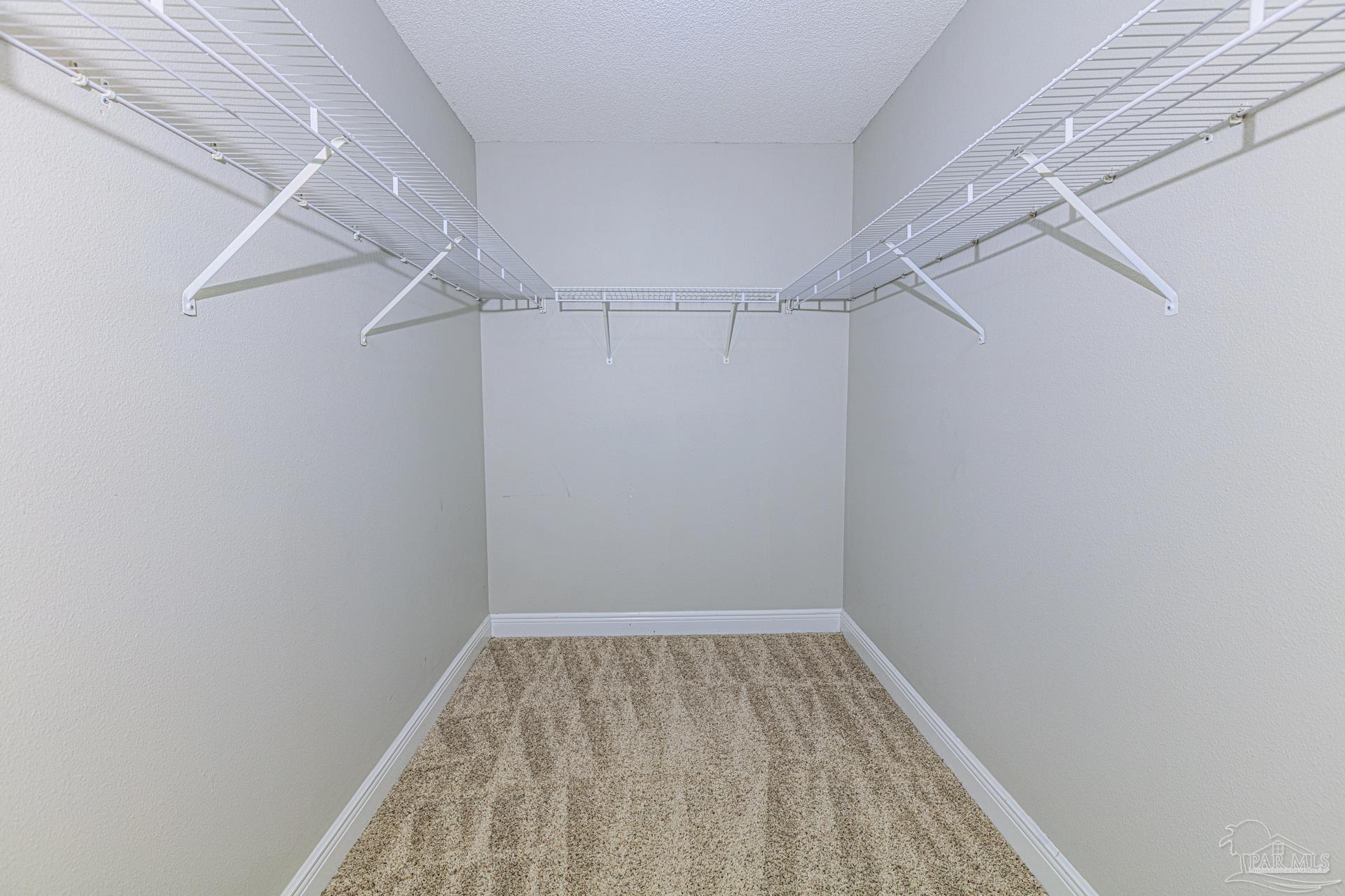 2863 Wallace Lake Road Pace, FL 32571 - Photo 17 of 44 a view of a room with racks on the wall