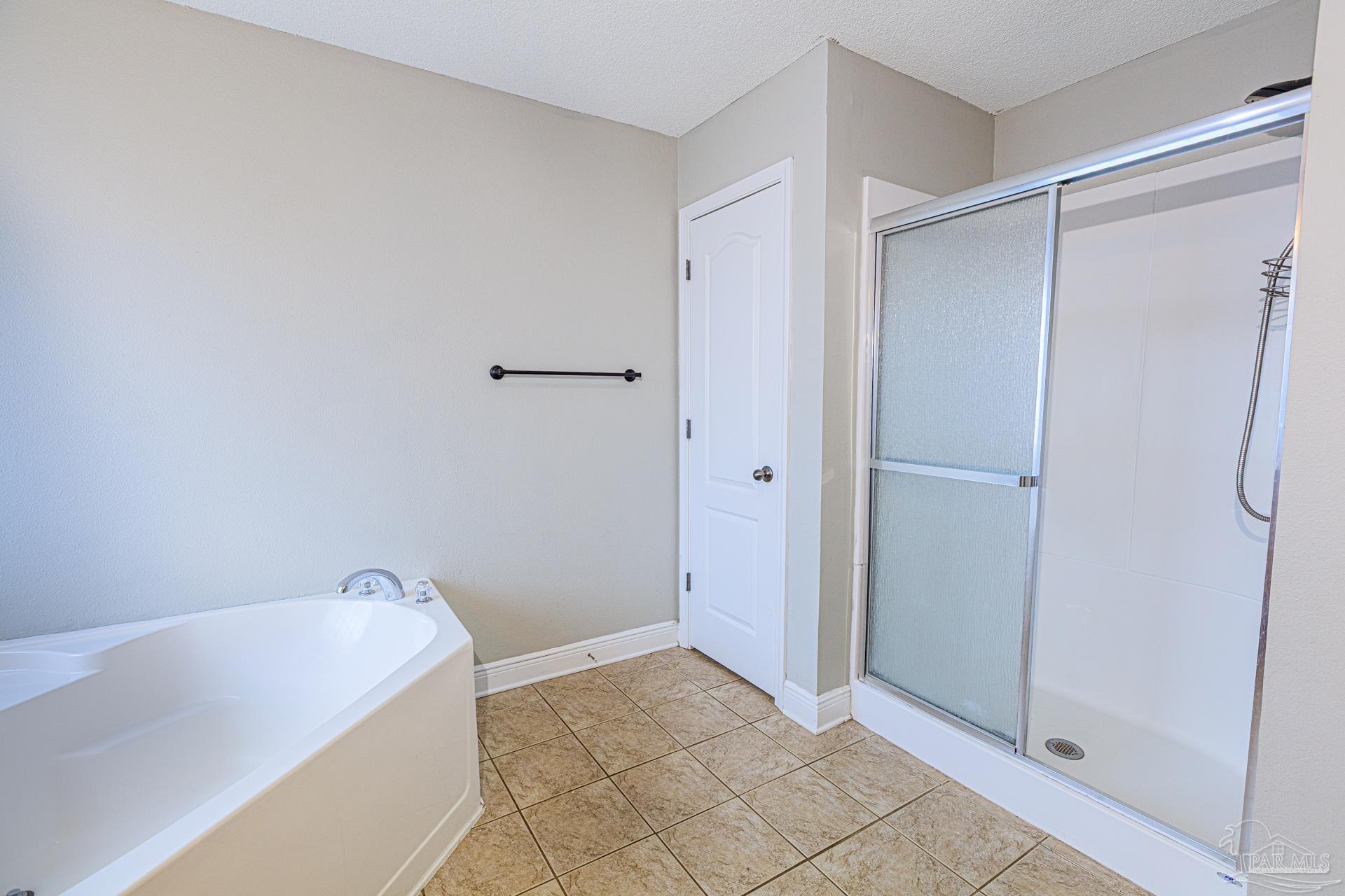 2863 Wallace Lake Road Pace, FL 32571 - Photo 18 of 44 a bathroom with a bathtub and shower