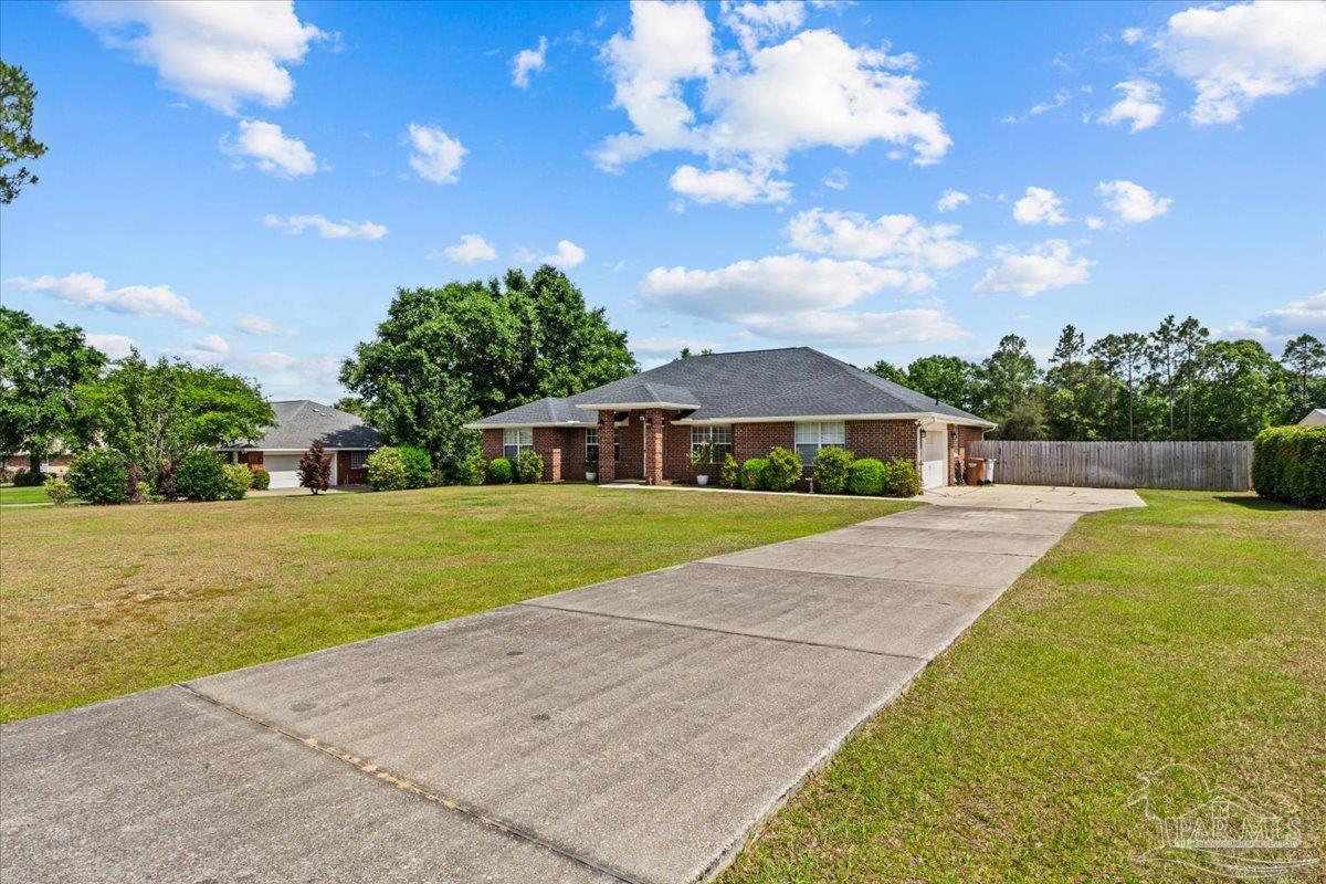 2863 Wallace Lake Road Pace, FL 32571 - Photo 2 of 44 a front view of a house with a yard