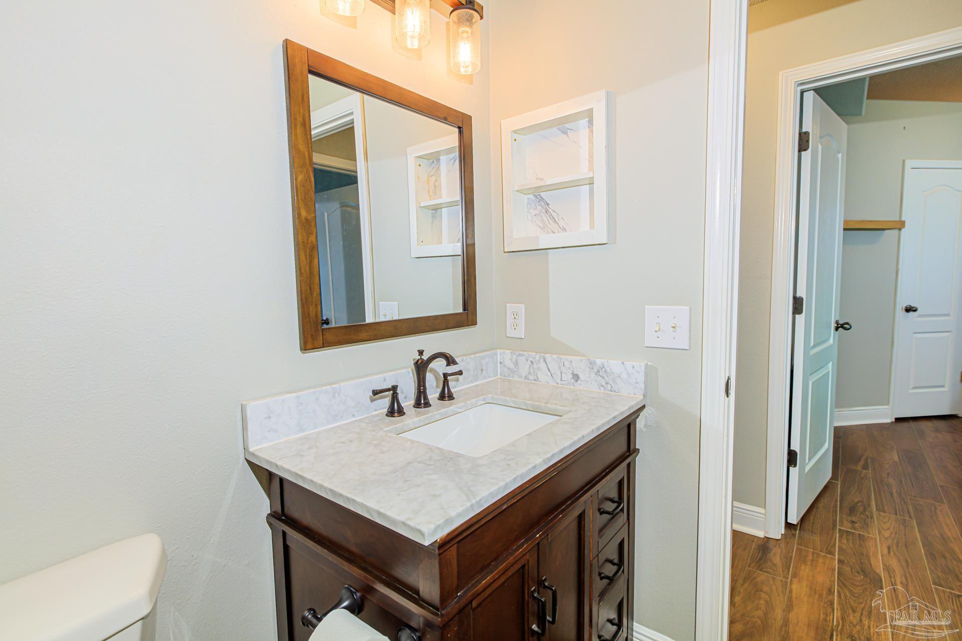 2863 Wallace Lake Road Pace, FL 32571 - Photo 21 of 44 a bathroom with a sink and a mirror