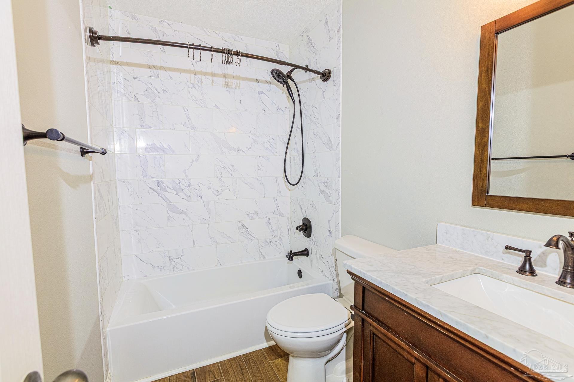 2863 Wallace Lake Road Pace, FL 32571 - Photo 22 of 44 a bathroom with a granite countertop sink toilet and shower