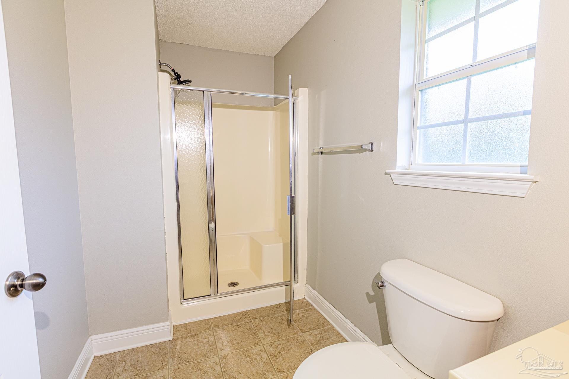2863 Wallace Lake Road Pace, FL 32571 - Photo 26 of 44 a bathroom with a toilet and a shower
