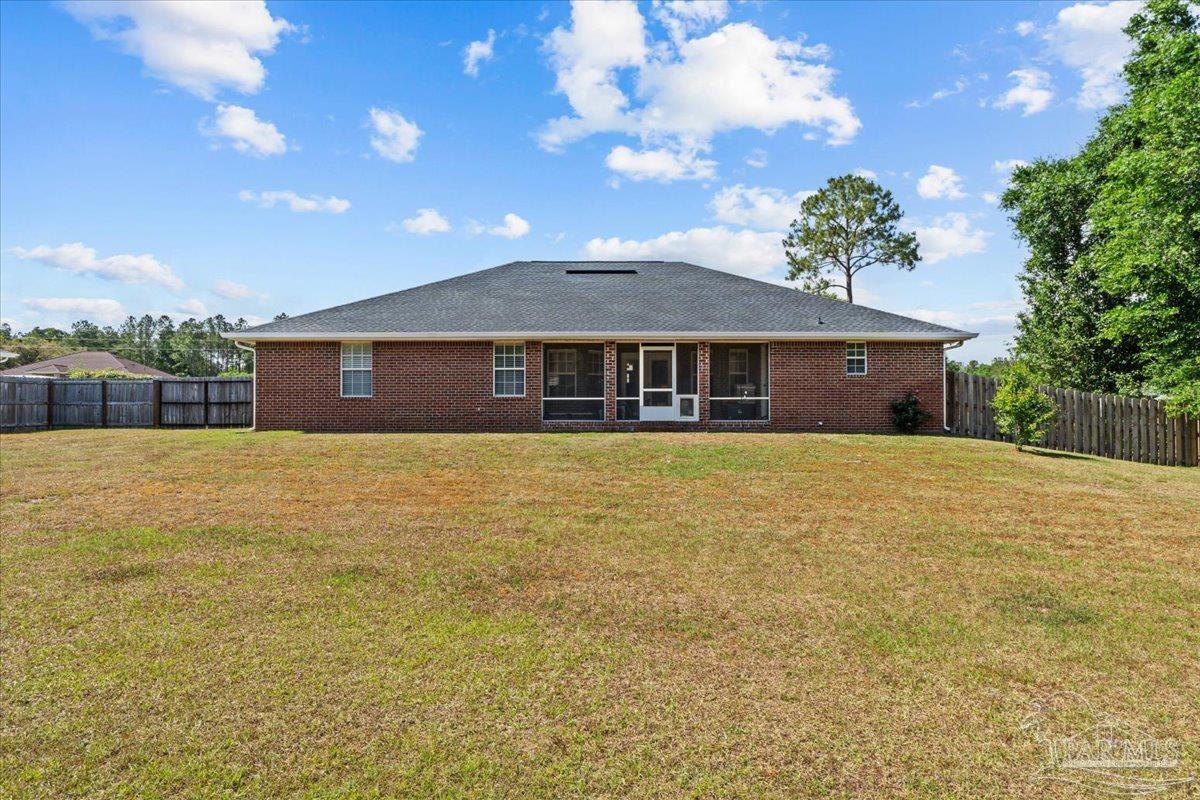 2863 Wallace Lake Road Pace, FL 32571 - Photo 30 of 44 a front view of a house with a garden