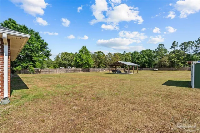 a view of a patio with table and chairs and potted plants