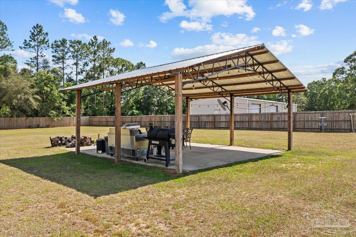 2863 Wallace Lake Road Pace, FL 32571 - Photo 32 of 44 a view of a swimming pool with chairs