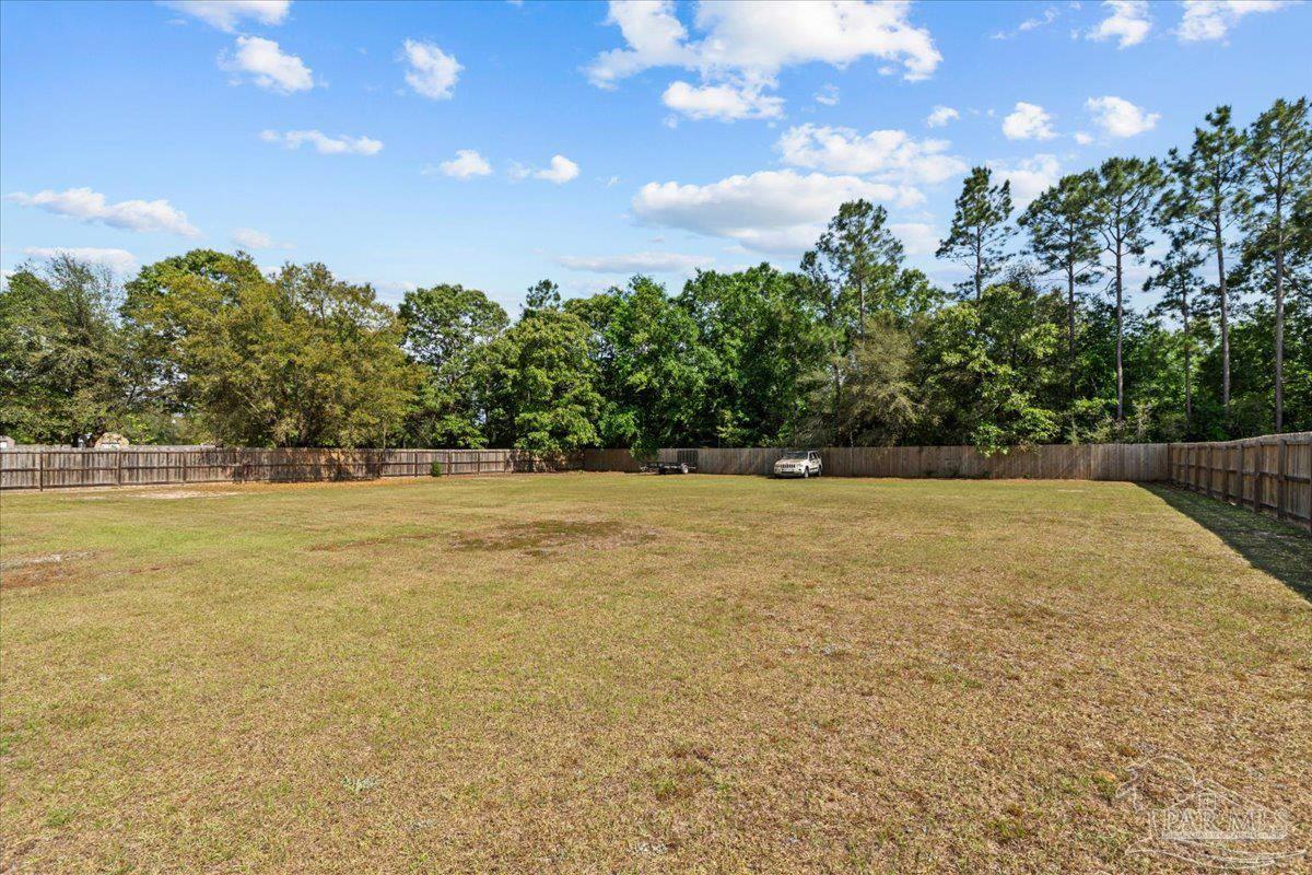 2863 Wallace Lake Road Pace, FL 32571 - Photo 35 of 44 a view of outdoor space with swimming pool and green space