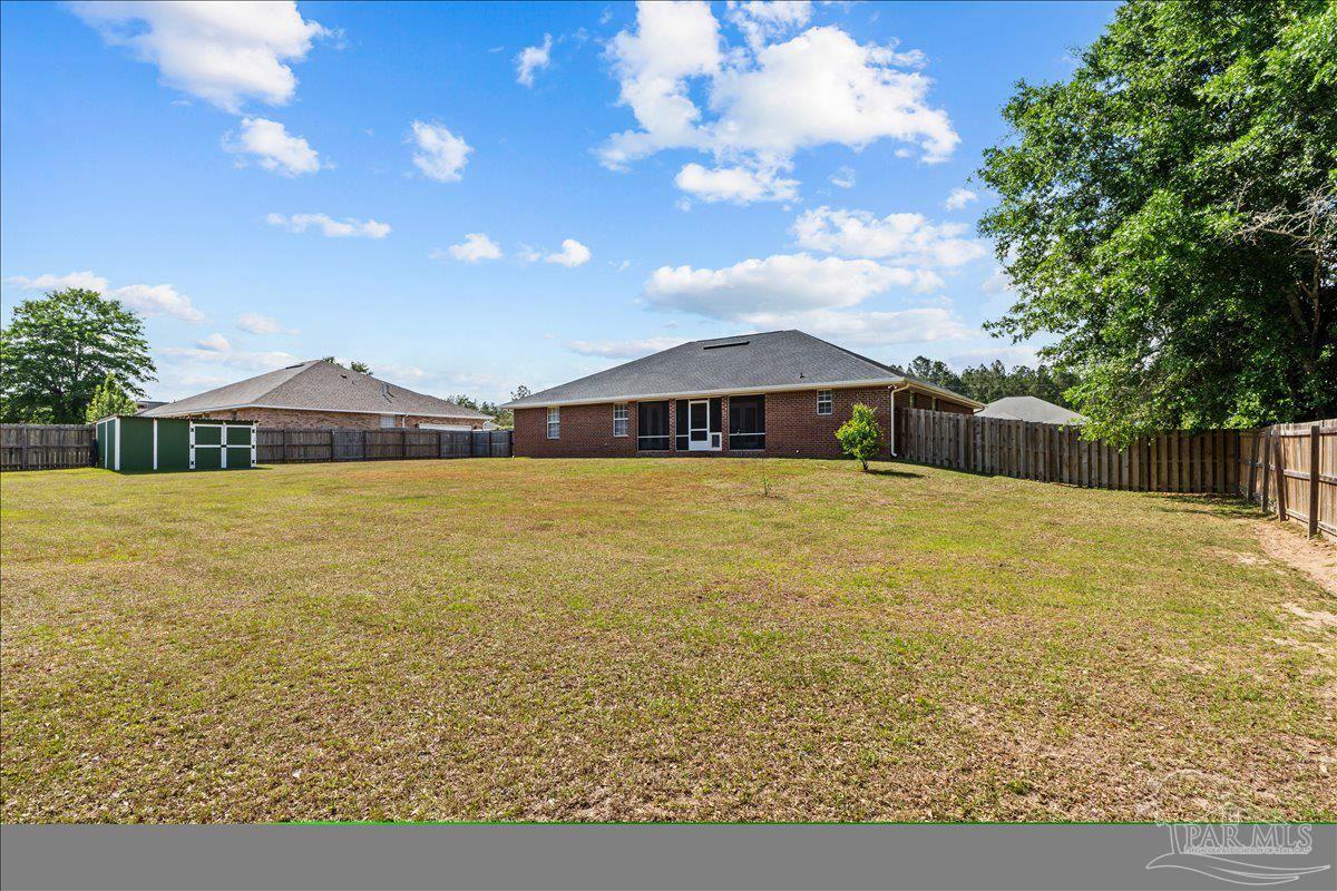2863 Wallace Lake Road Pace, FL 32571 - Photo 37 of 44 a view of a house with swimming pool and a yard
