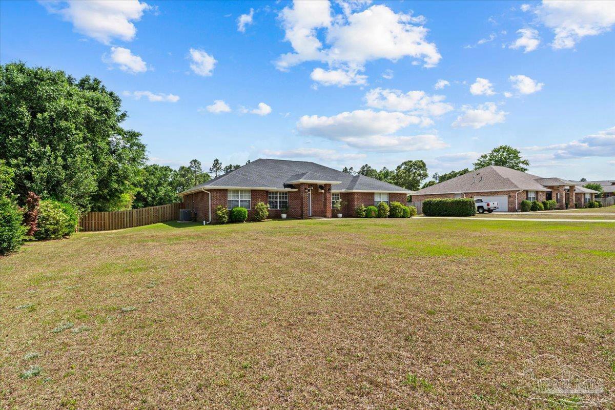 2863 Wallace Lake Road Pace, FL 32571 - Photo 4 of 44 a front view of a house with garden