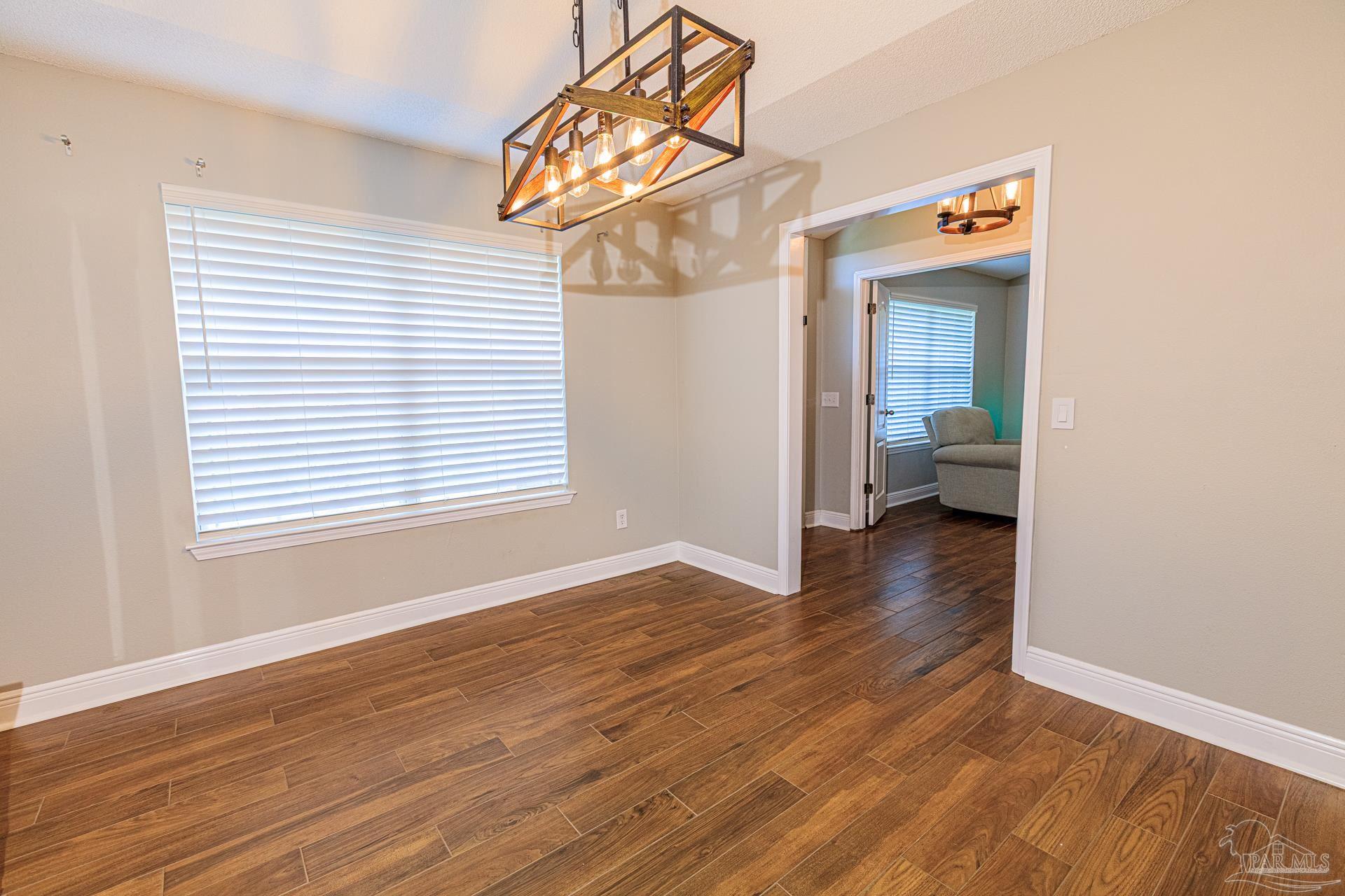 2863 Wallace Lake Road Pace, FL 32571 - Photo 6 of 44 a view of a room that has a window and wooden floor