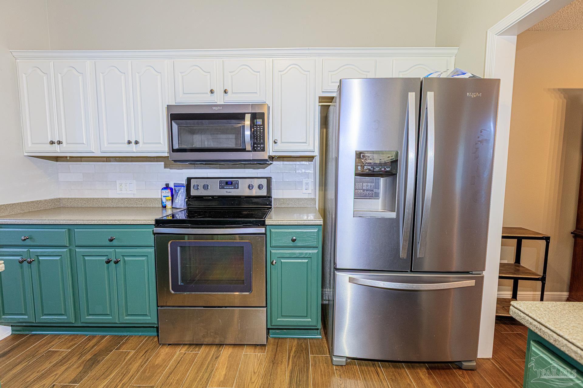 2863 Wallace Lake Road Pace, FL 32571 - Photo 9 of 44 a kitchen with stainless steel appliances granite countertop a refrigerator stove and microwave