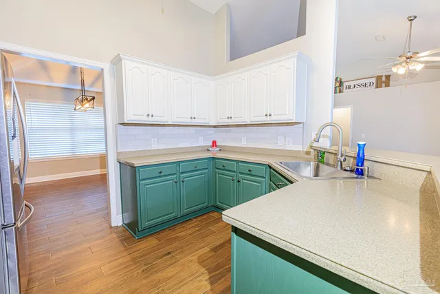 a kitchen with cabinets and appliances