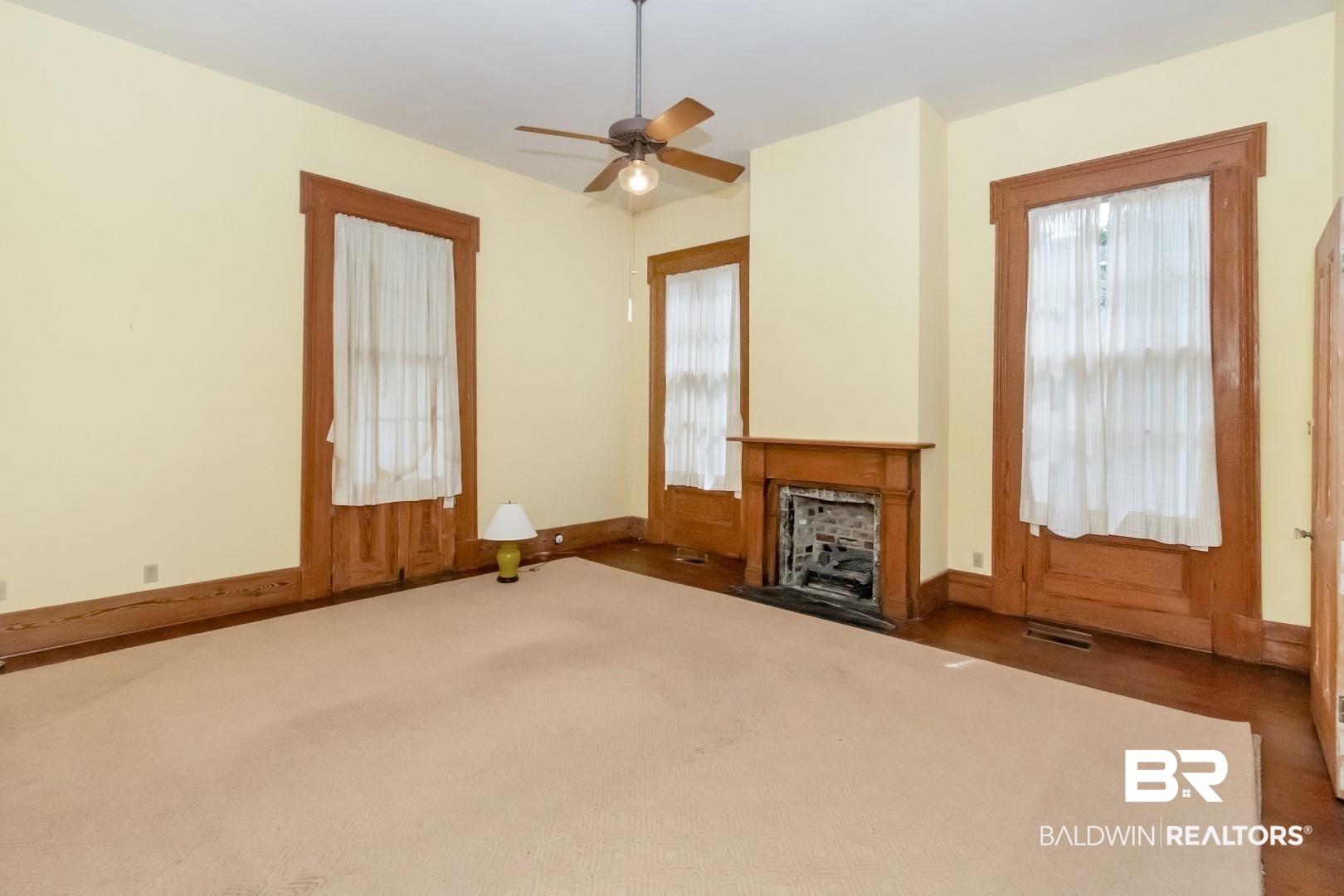 959 Dauphin Street Mobile, AL 36604 - Photo 14 of 43 Unfurnished living room featuring dark hardwood / wood-style flooring, a wealth of natural light, and ceiling fan