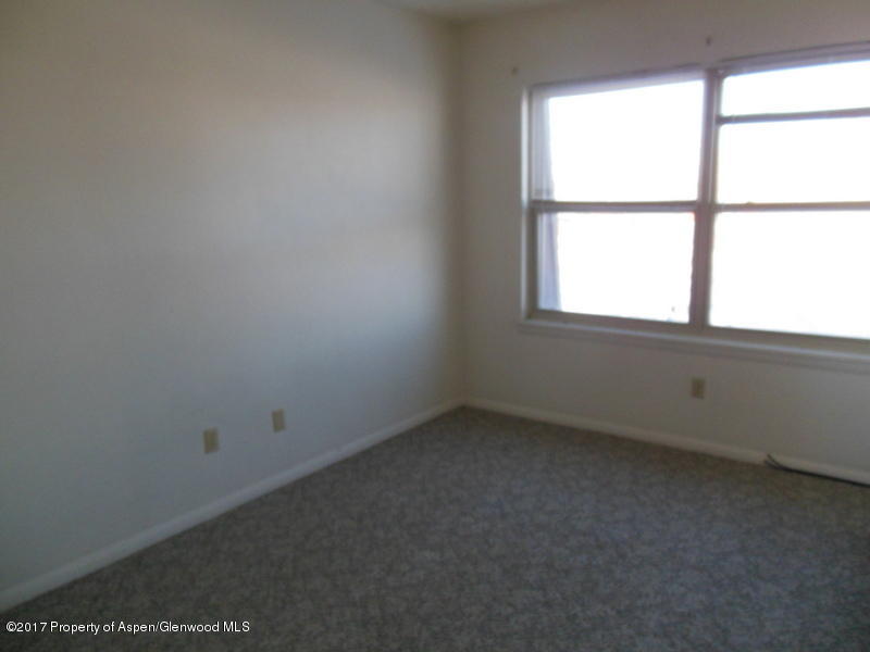 1393 West 2nd Street Craig, CO 81625 - Photo 12 of 16 an empty room with a window