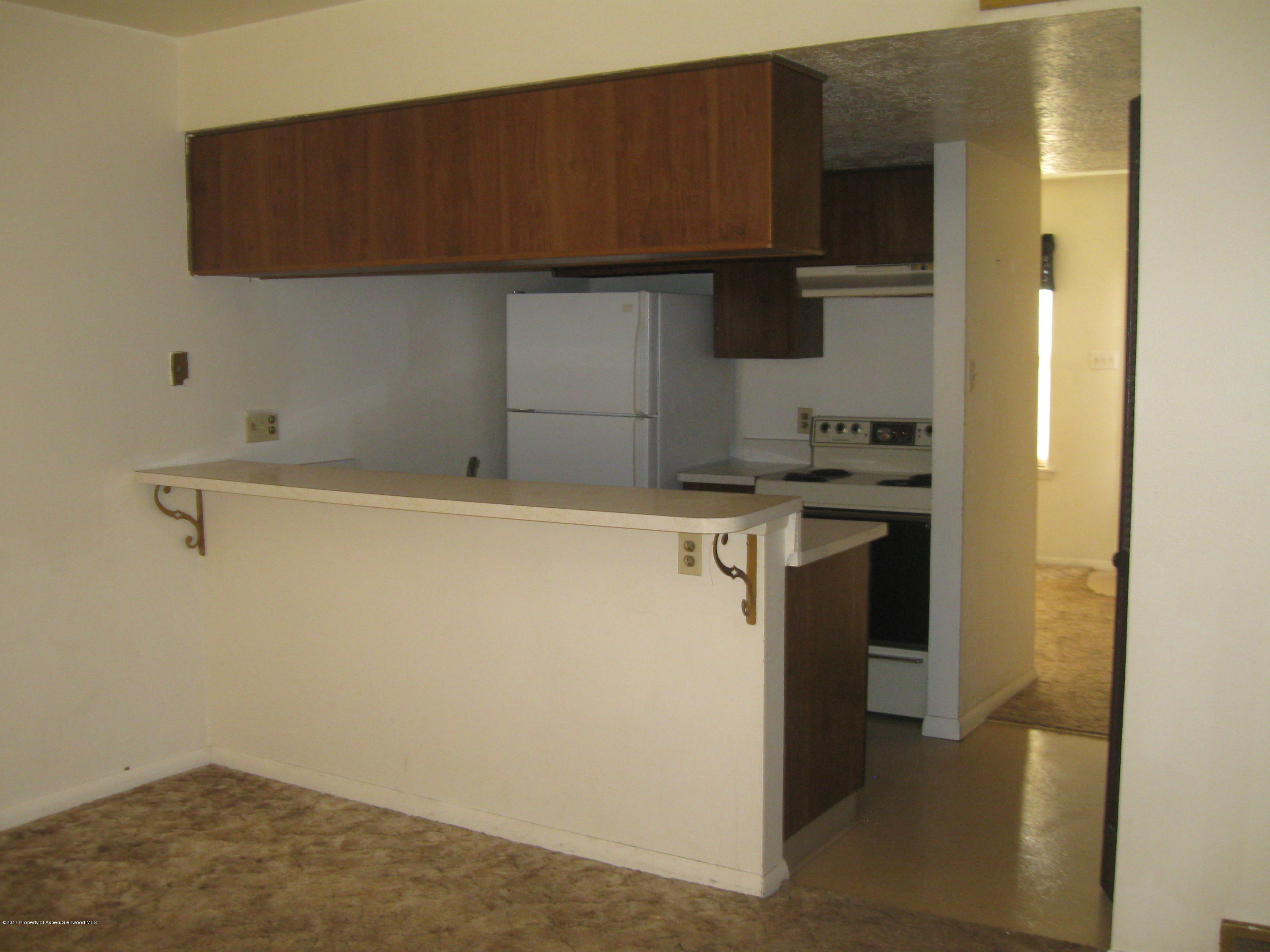 1393 West 2nd Street Craig, CO 81625 - Photo 16 of 16 a kitchen with a sink and cabinets