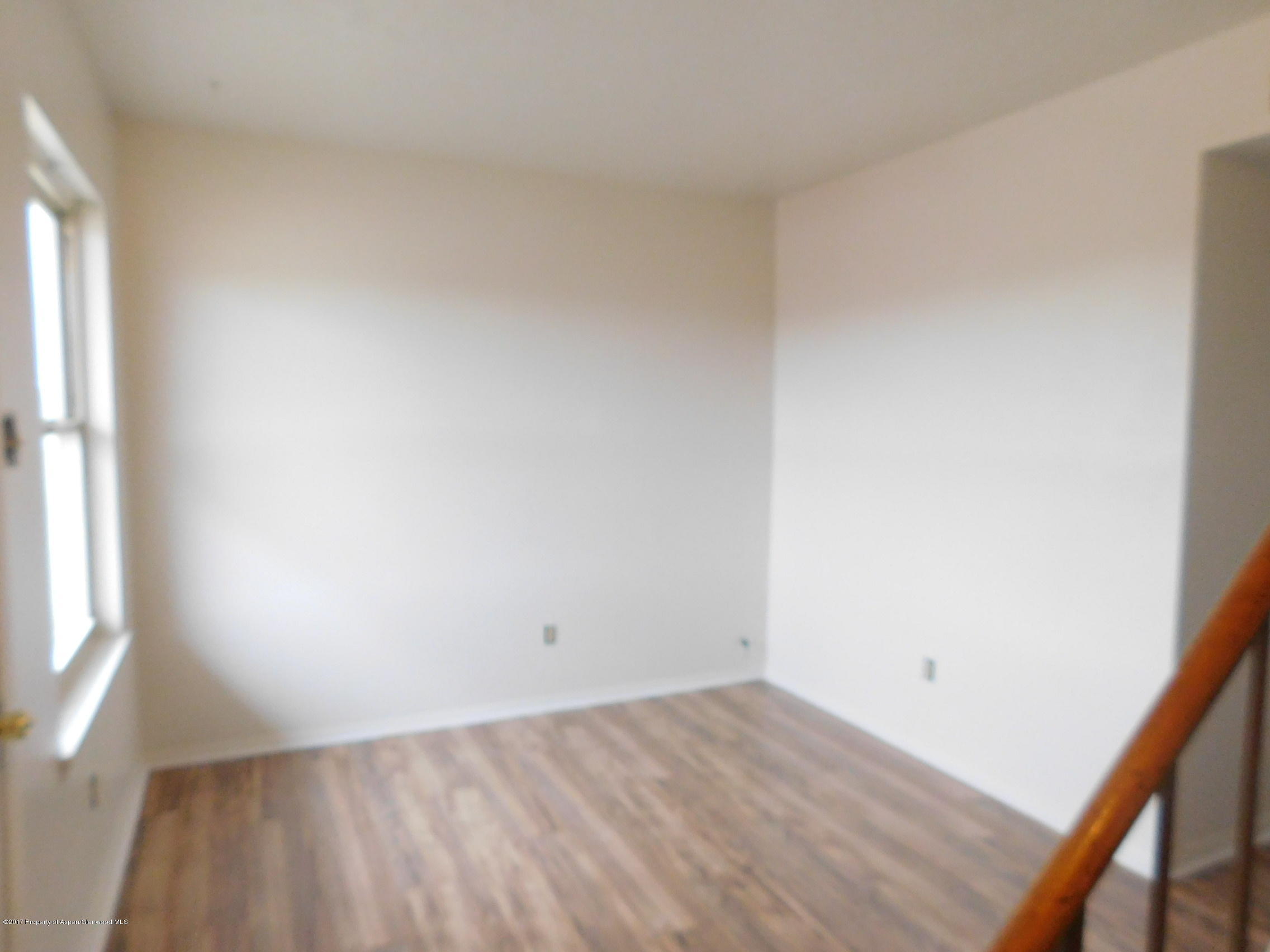 1393 West 2nd Street Craig, CO 81625 - Photo 2 of 16 an empty room with a window